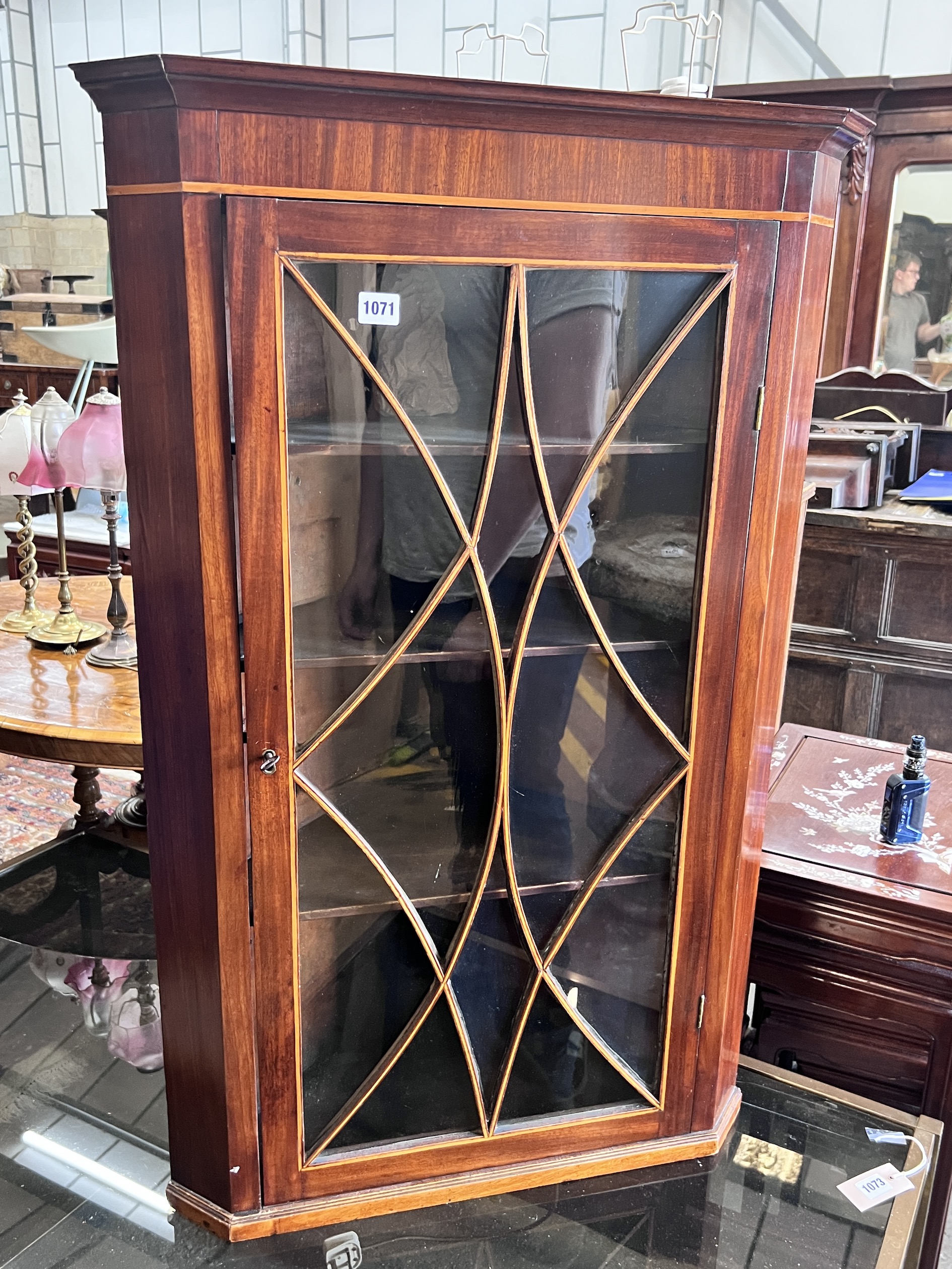 A George III inlaid mahogany hanging corner cupboard, width 64cm, depth 38cm, height 100cm